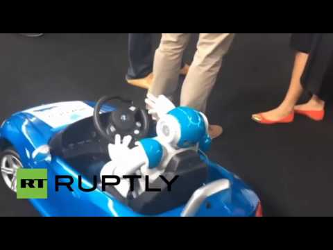 رجل آليّ ينجح في قيادة سيّارة بي إم دبليو صغيرة